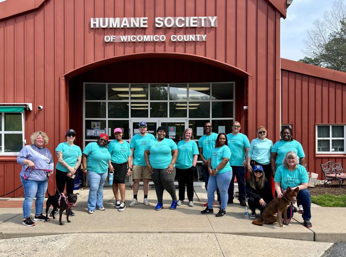  group of volunteers posed outside a building "Humane Society".