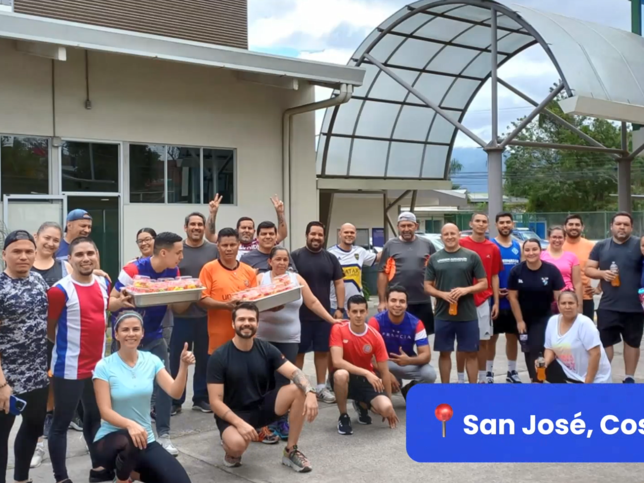 Group of employees posed outside. "San Jose, Costa Rica" in the corner.