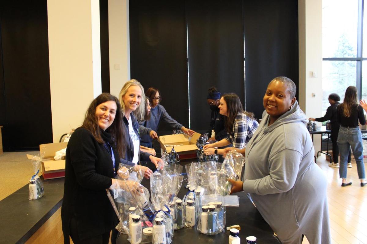 Bath & Body Works associates gather to support women transitioning from the program and into new homes by creating Bath & Body 
