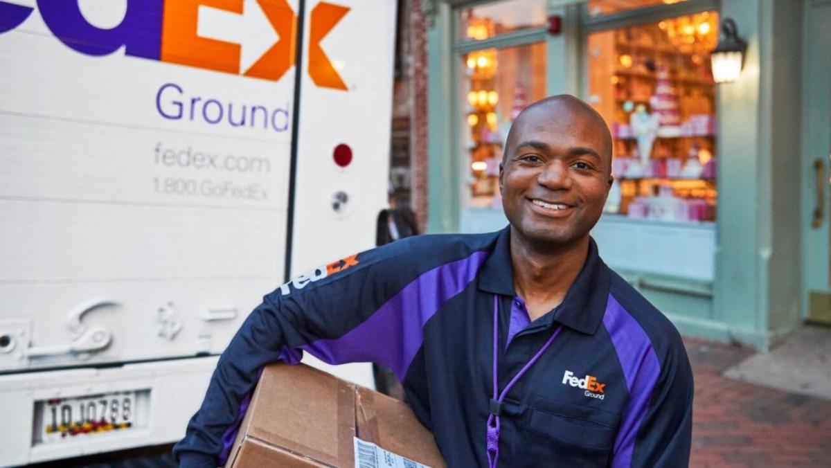 FedEx delivery driver holding a parcel 