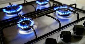 A gas range with all four burners on.