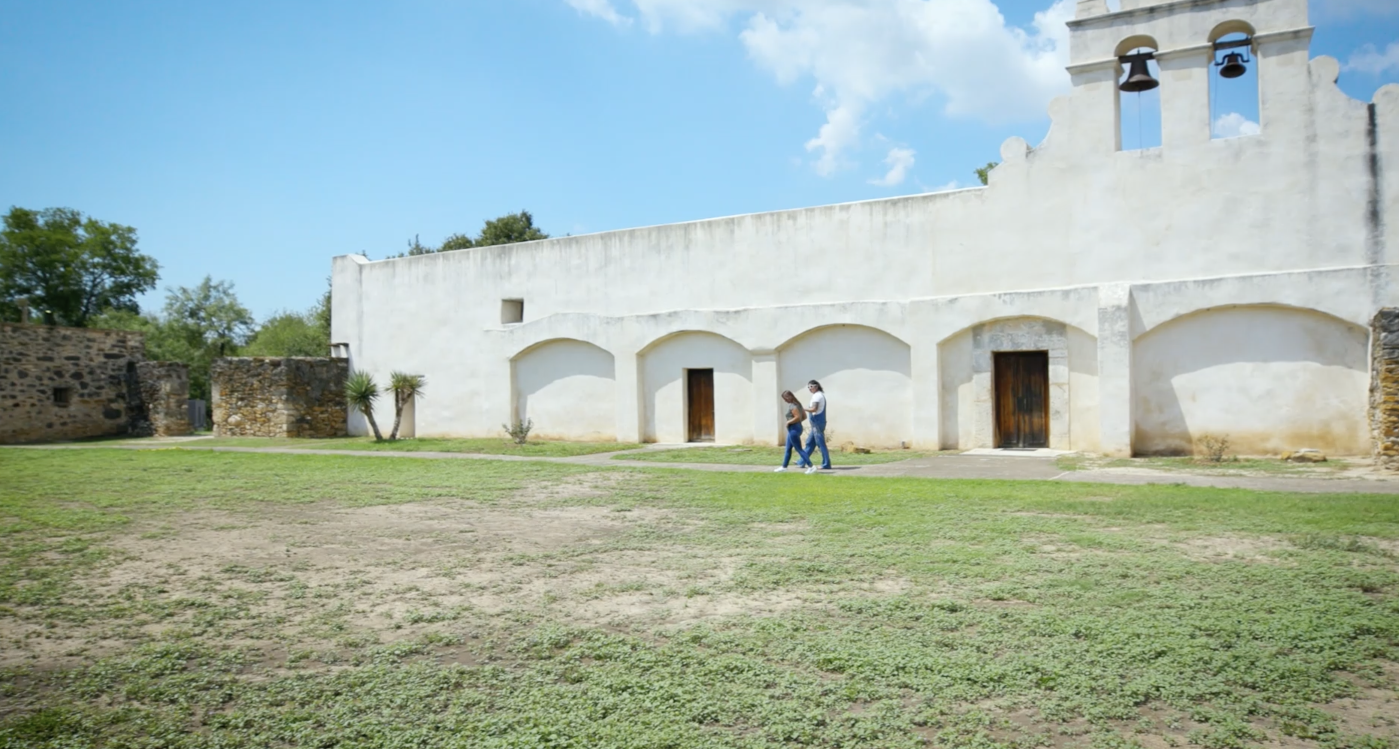 2 people walking outside a church