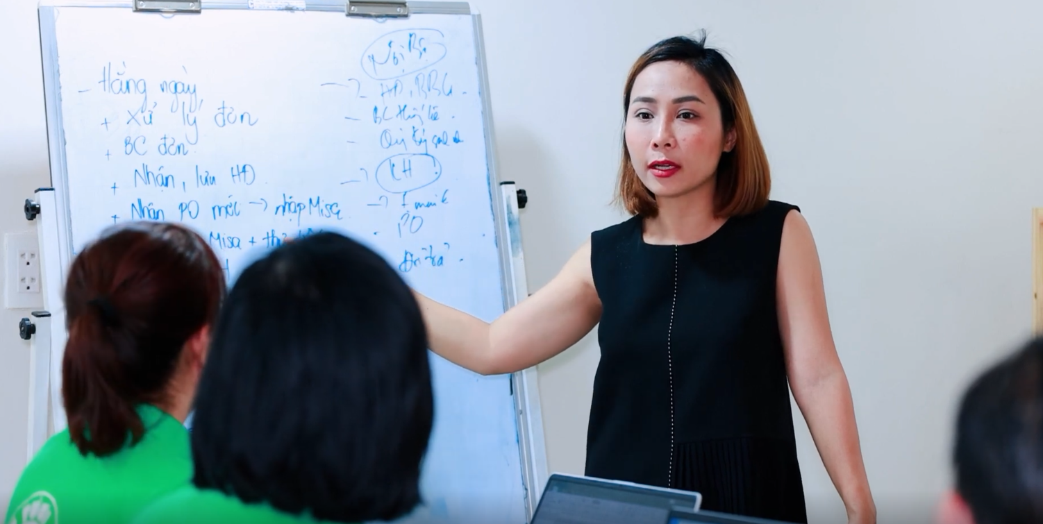 Van Pham in front of a white board