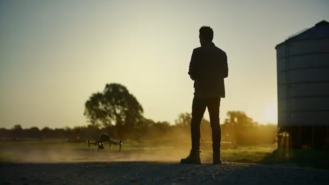 Silouette of man with flying a drone