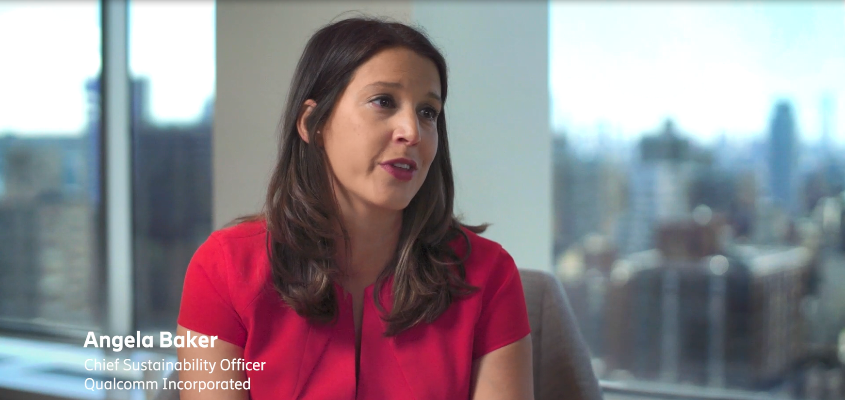 Angela Baker speaking in an office setting.