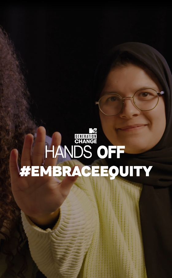 Mariam Khan with outstretched hand "Hands Off. EmbraceEquity."