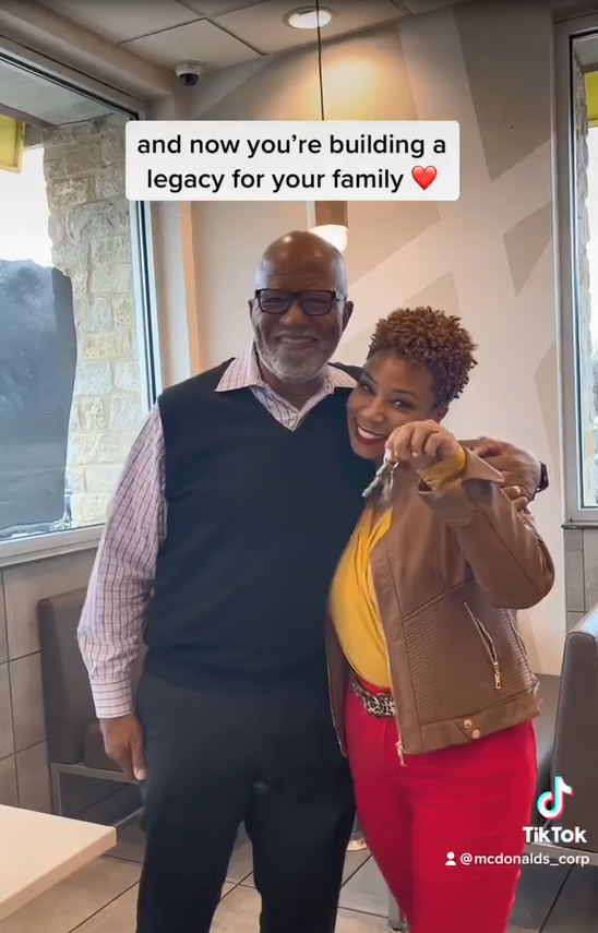 Aaron Harris and Joy Silmon with arms around each other, Joy holds a set of keys.