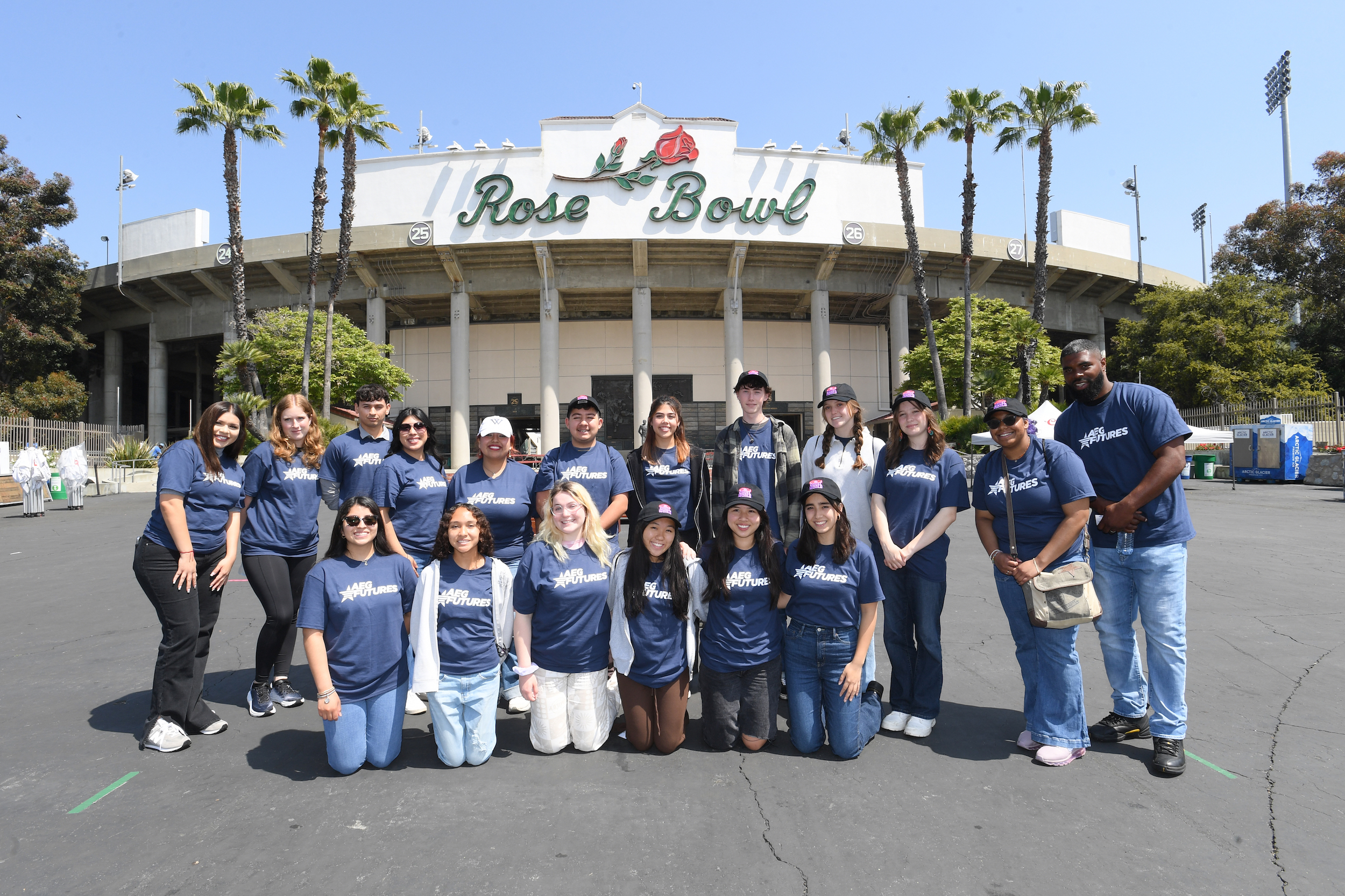 Students pose in front of the Rose Bowl stadium.