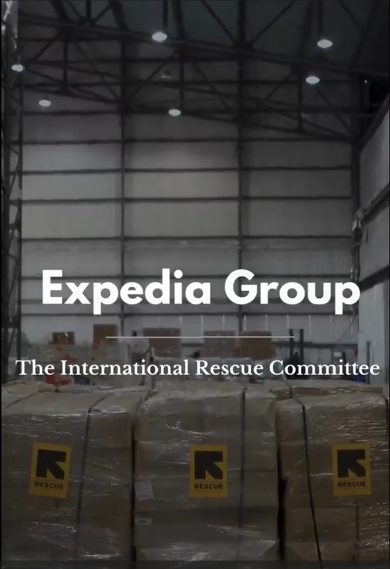 Expedia Group and The International Rescue committee over a photo of a warehouse with boxed pallets