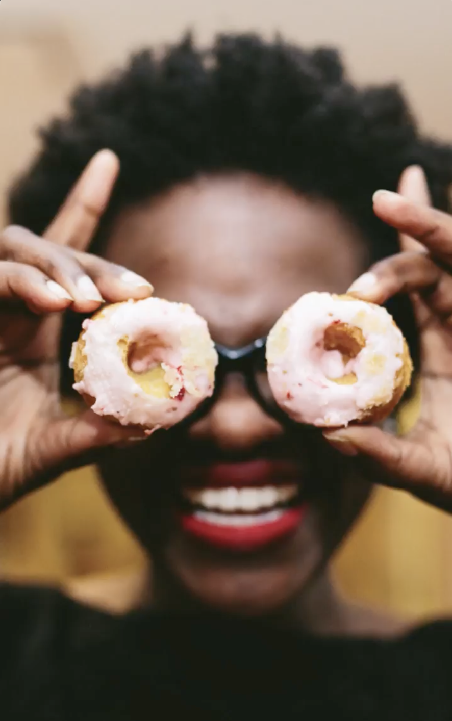 Holding two cookies as eyes