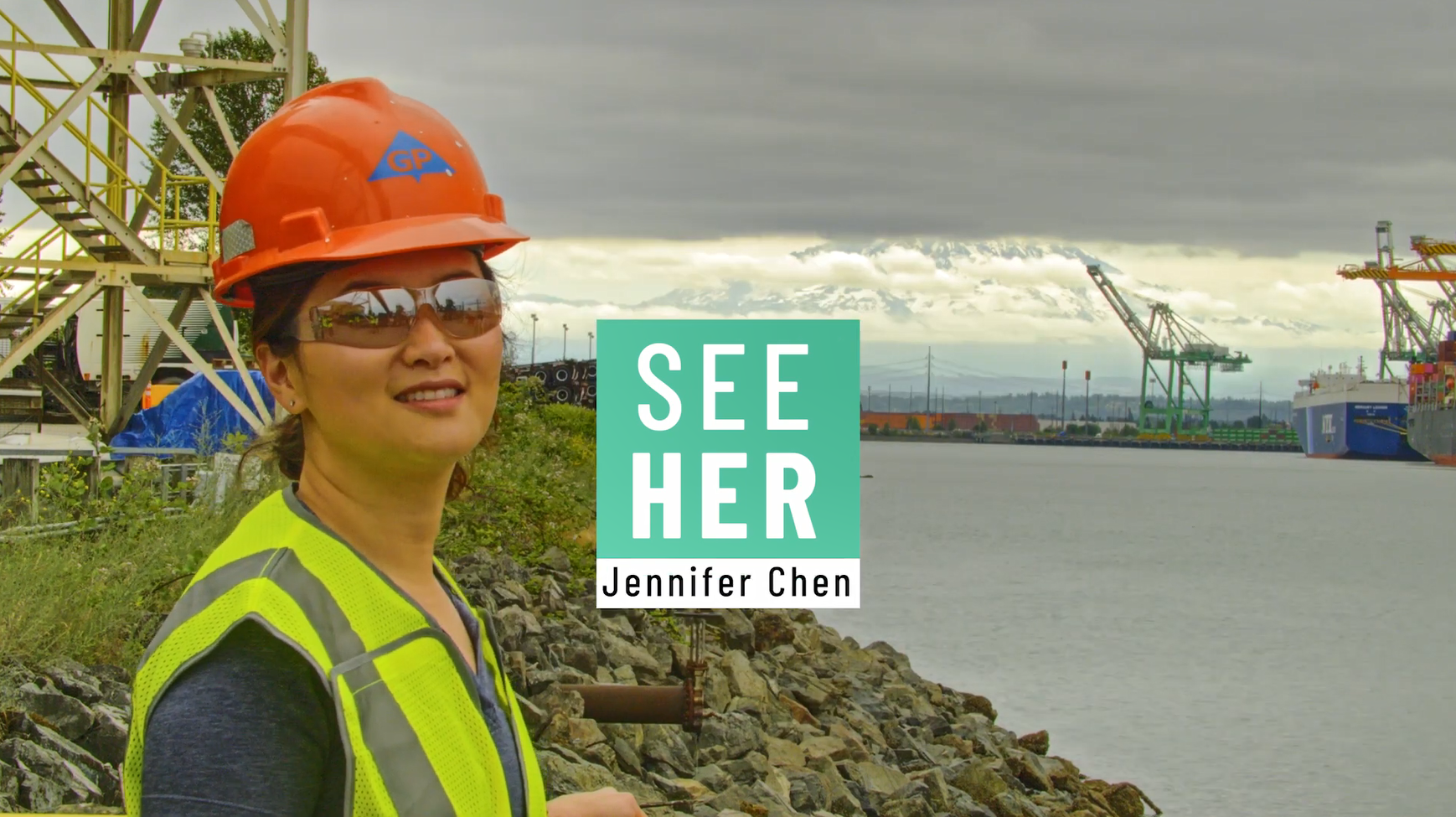 Jennifer Chen outside with a waterway and industrial machinery behind her. "SeeHer Jennifer Chen".