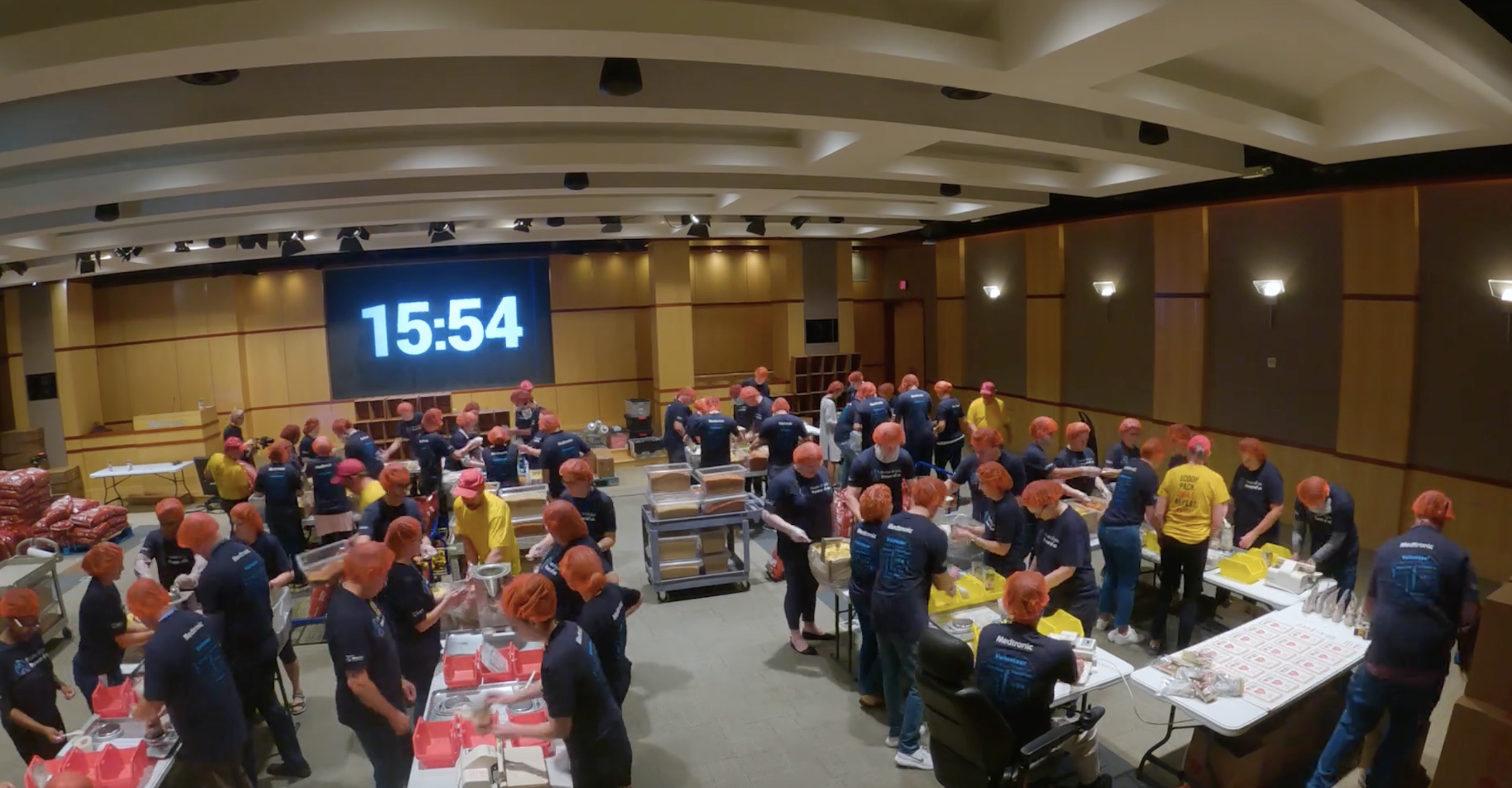 Medtronic volunteers working with a clock on the wall behind them