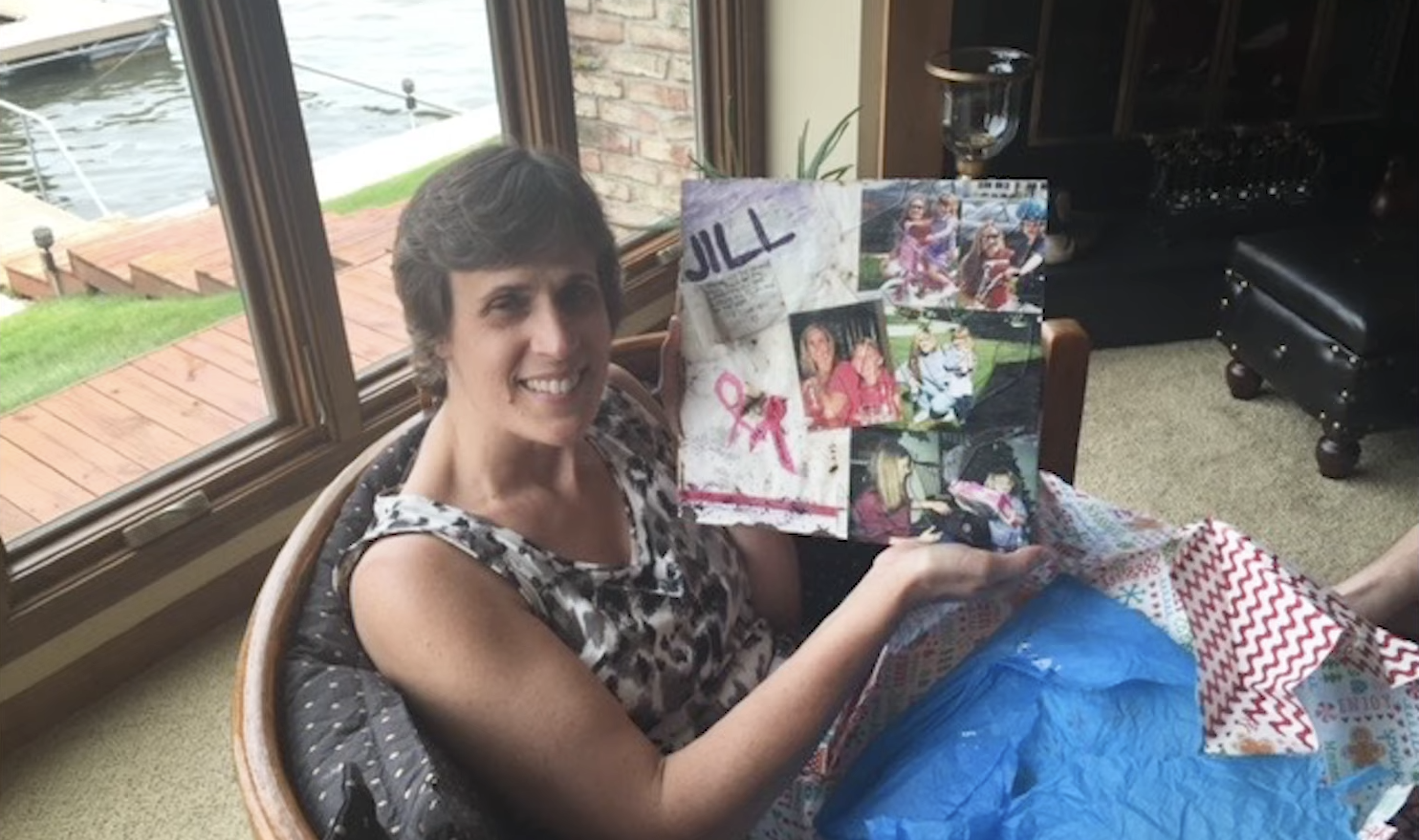 Jill Stair holding up a collage of photos
