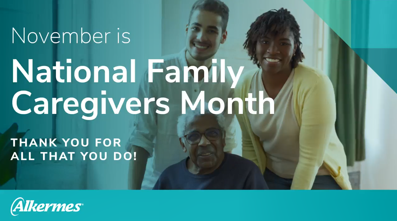 Two people standing behind a third seated. "November is National Family Caregivers Month. Thank you for all that you do."