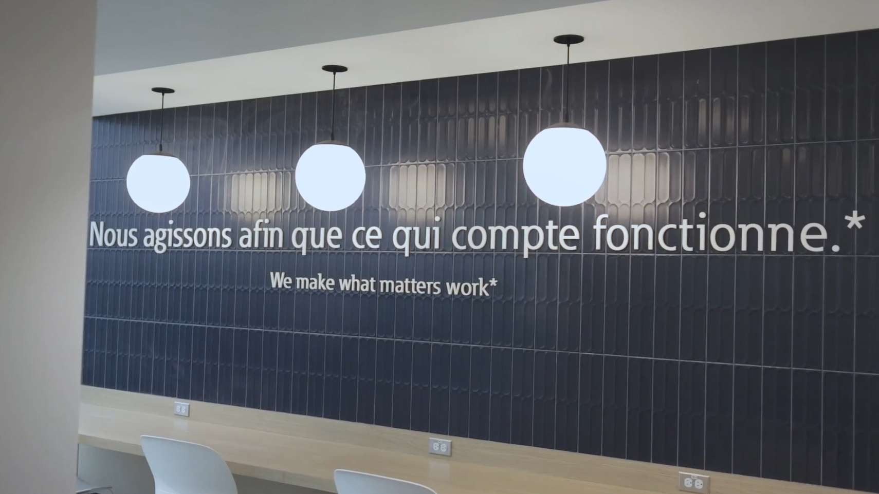 Slogan on a wall in an office setting.