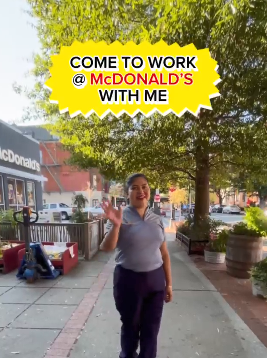 Maria Angela waving outside a McDonalds.
