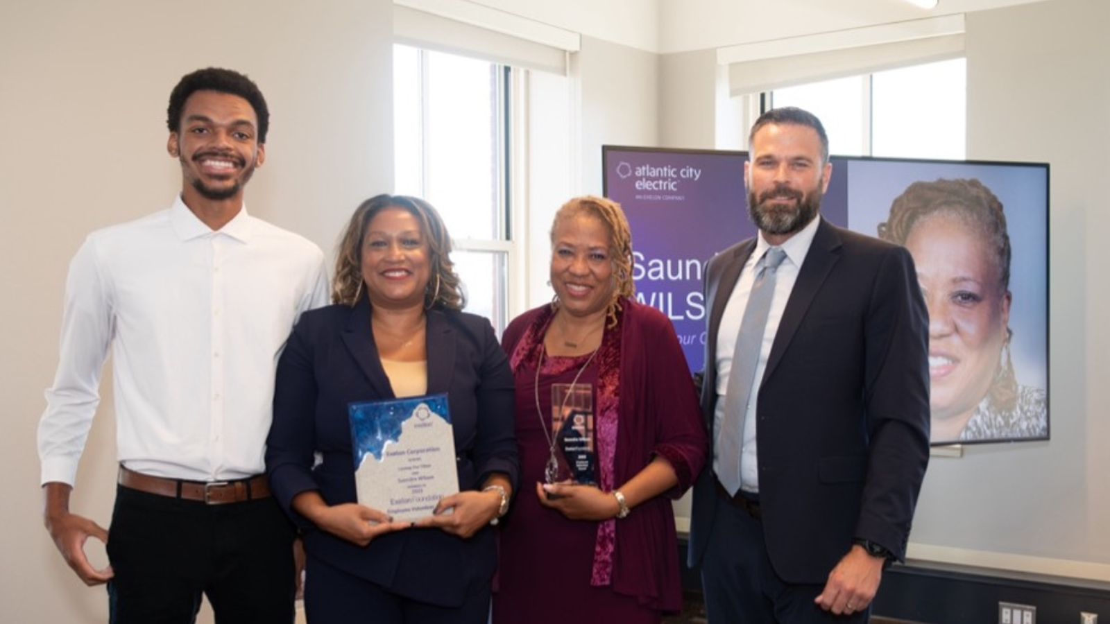 Saundra Wilson and three others posed with awards.