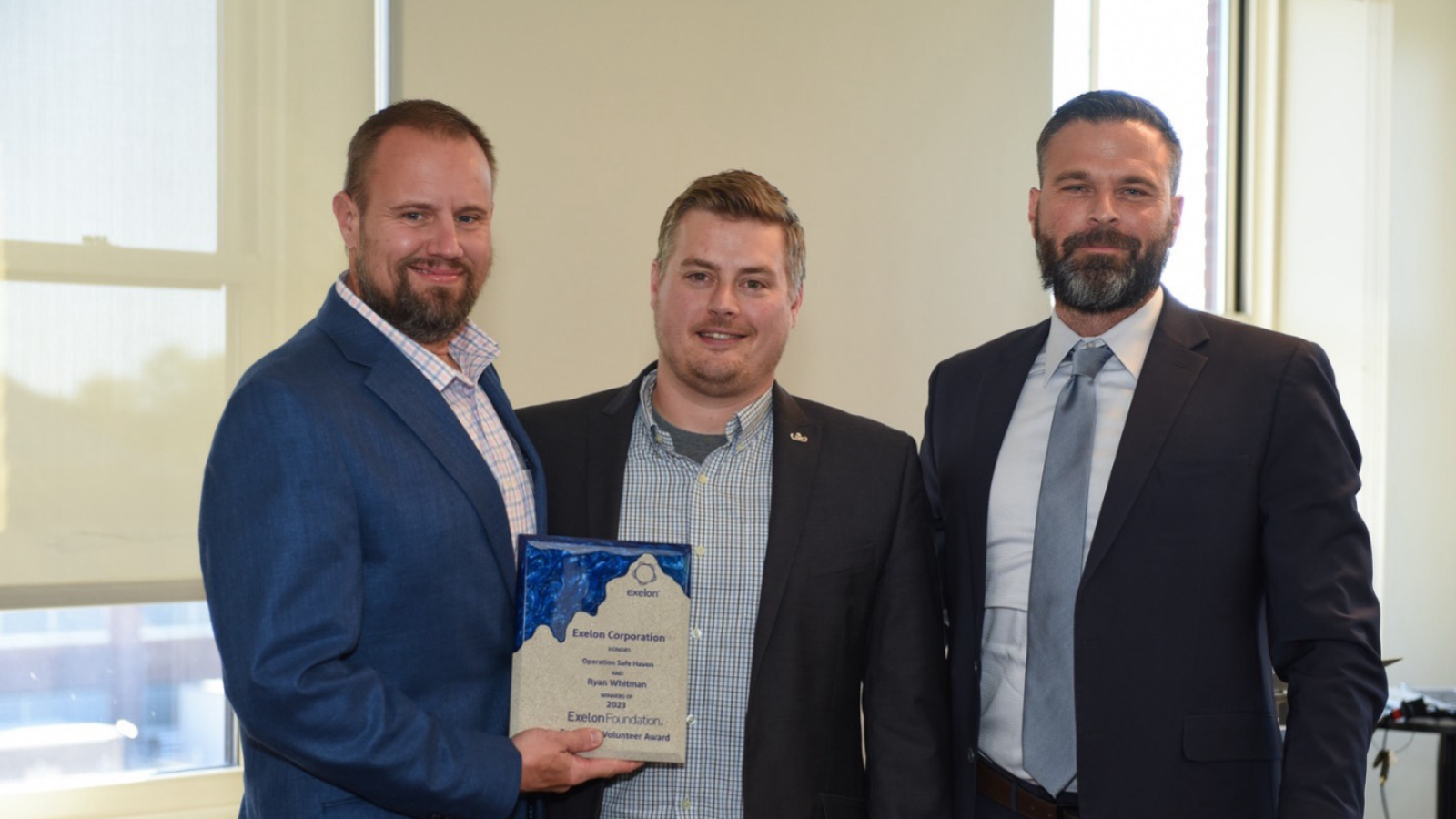 3 people accepting an award