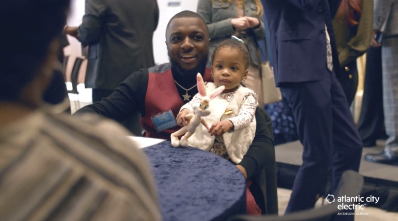 Parent holding child at table