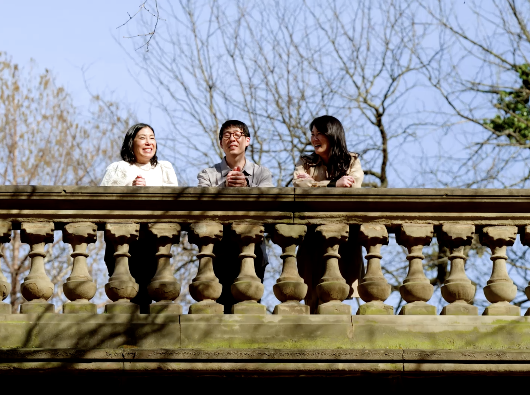 3 people standing on a bridge