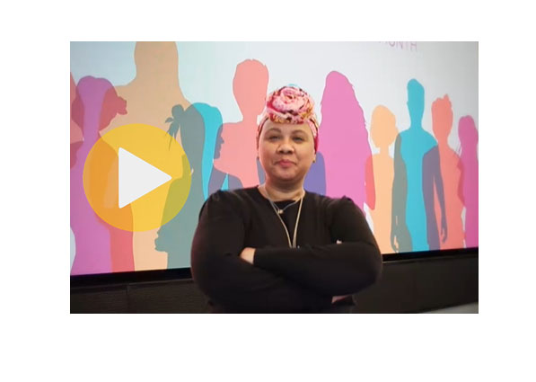 Image of a Black woman wearing a black top with her hair wrapped in a colorful scarf 