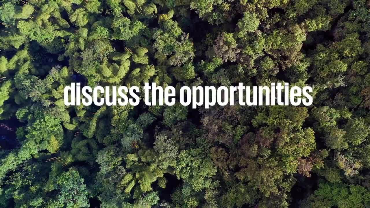 "discuss the opportunities" over an aerial view of a dense tree canopy.