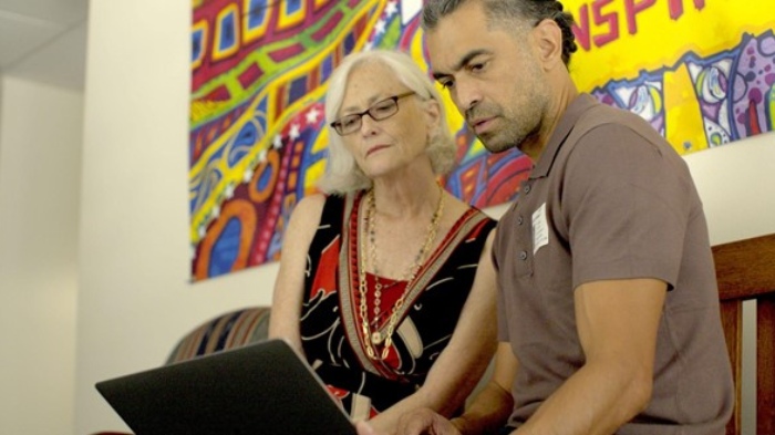 People looking at a laptop screen