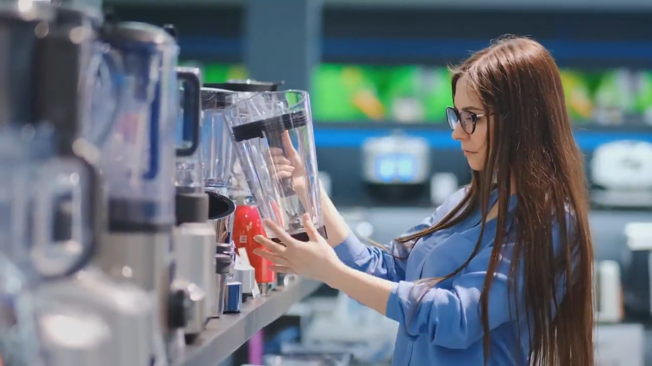 A person holding a blender