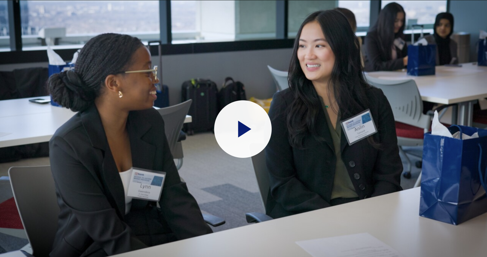 Two women seated at a table having a conversation.