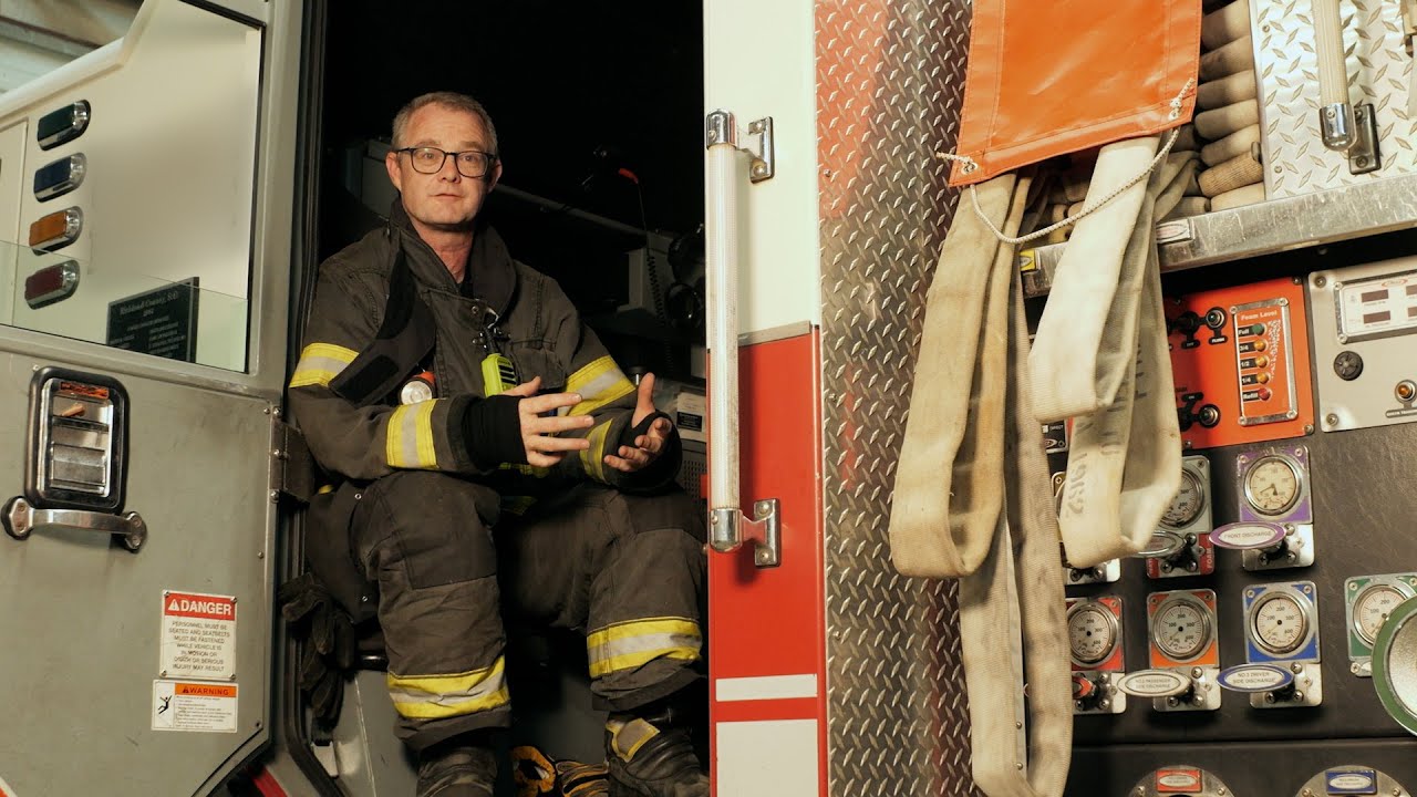 Nigel Graham sitting in a firetruck