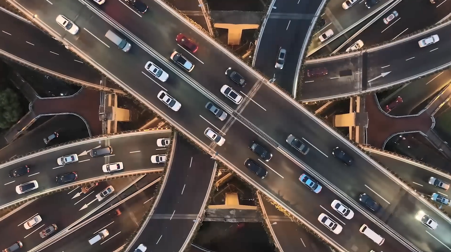 Aerial view of cars driving on multi-lane and multi-level highways.