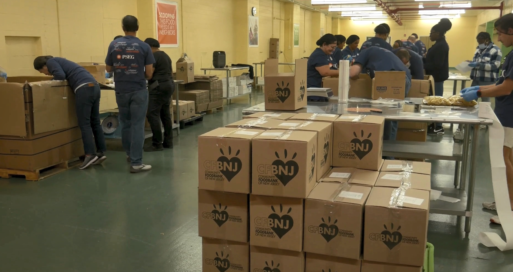 volunteers packing boxes with food items.