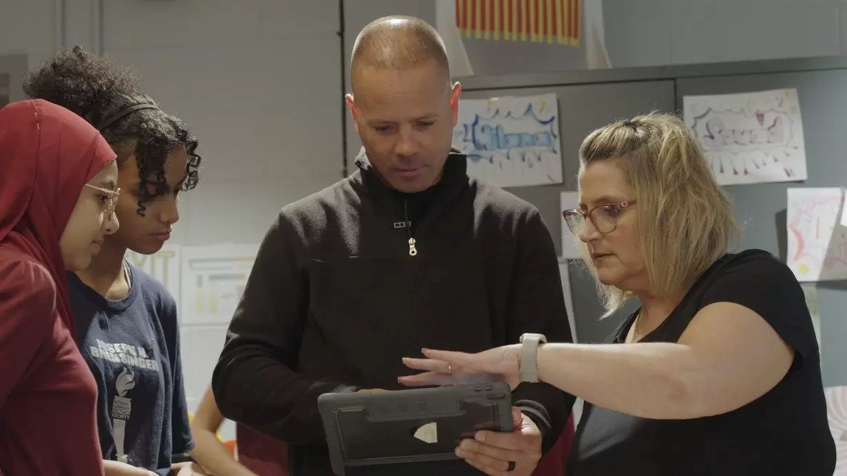 Jack Maher, a math teacher, shows students the augmented reality app.