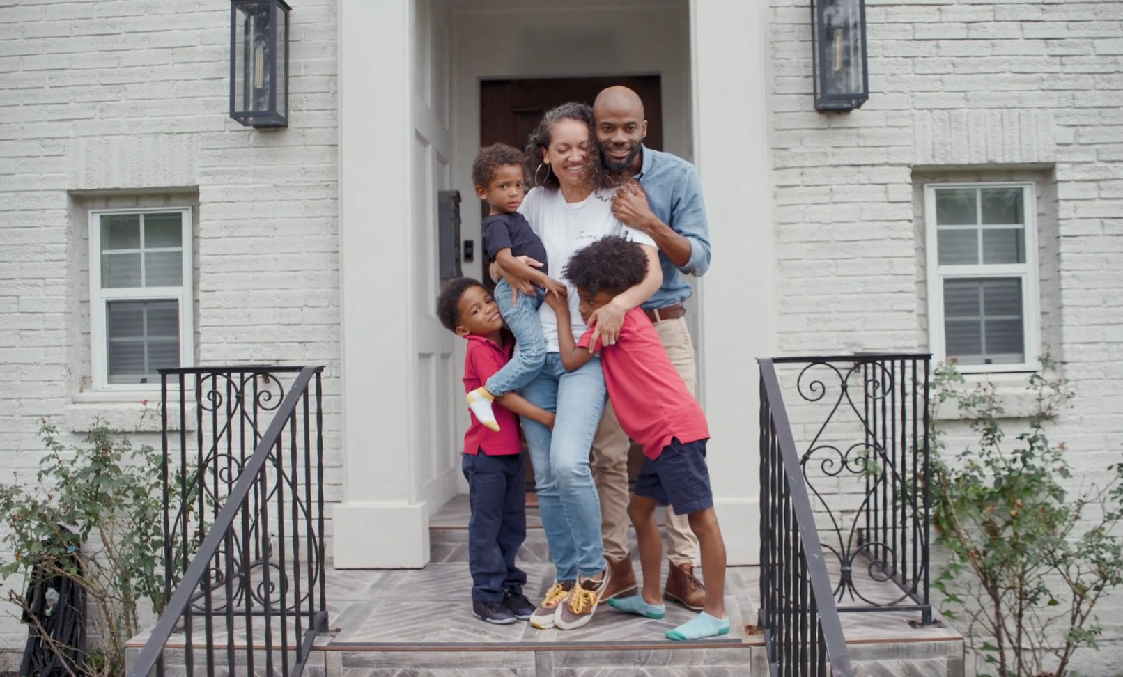 Kenzel Fallen and family on a front porch.