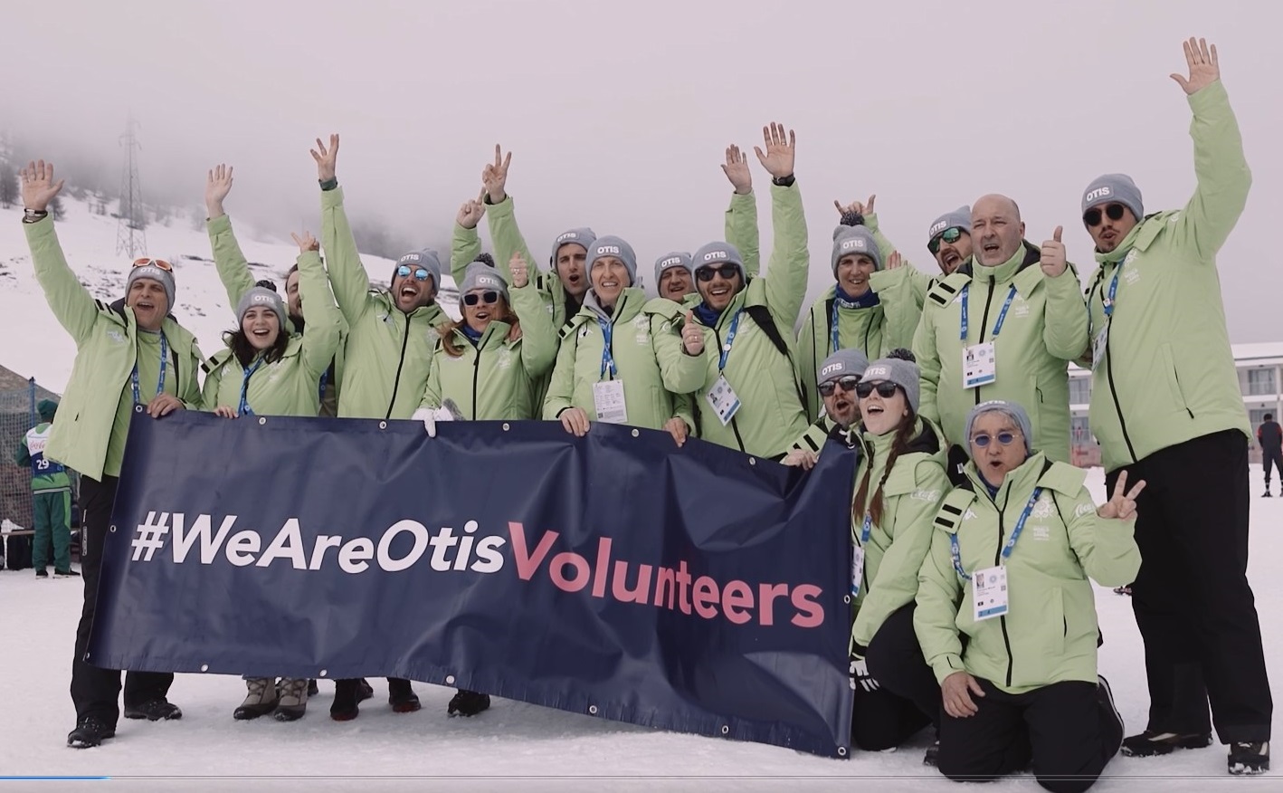 Group of Otis volunteers holding We Are Otis banner.