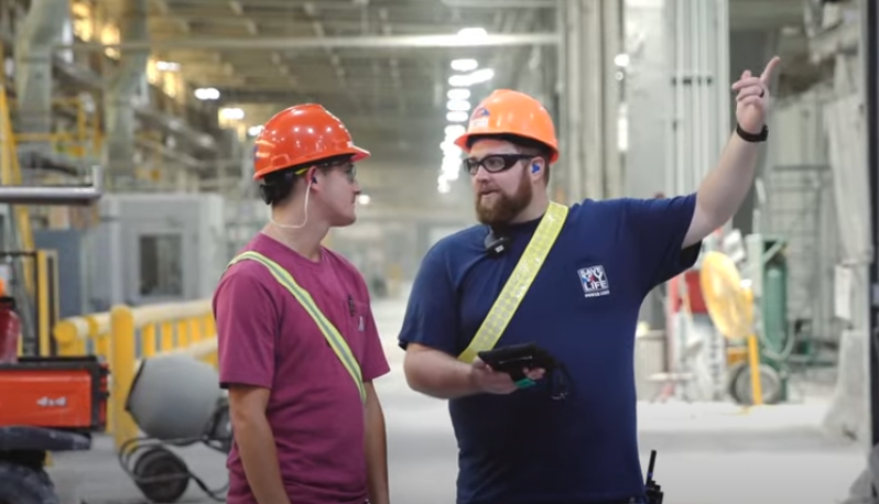 Two workers in orange hard hats