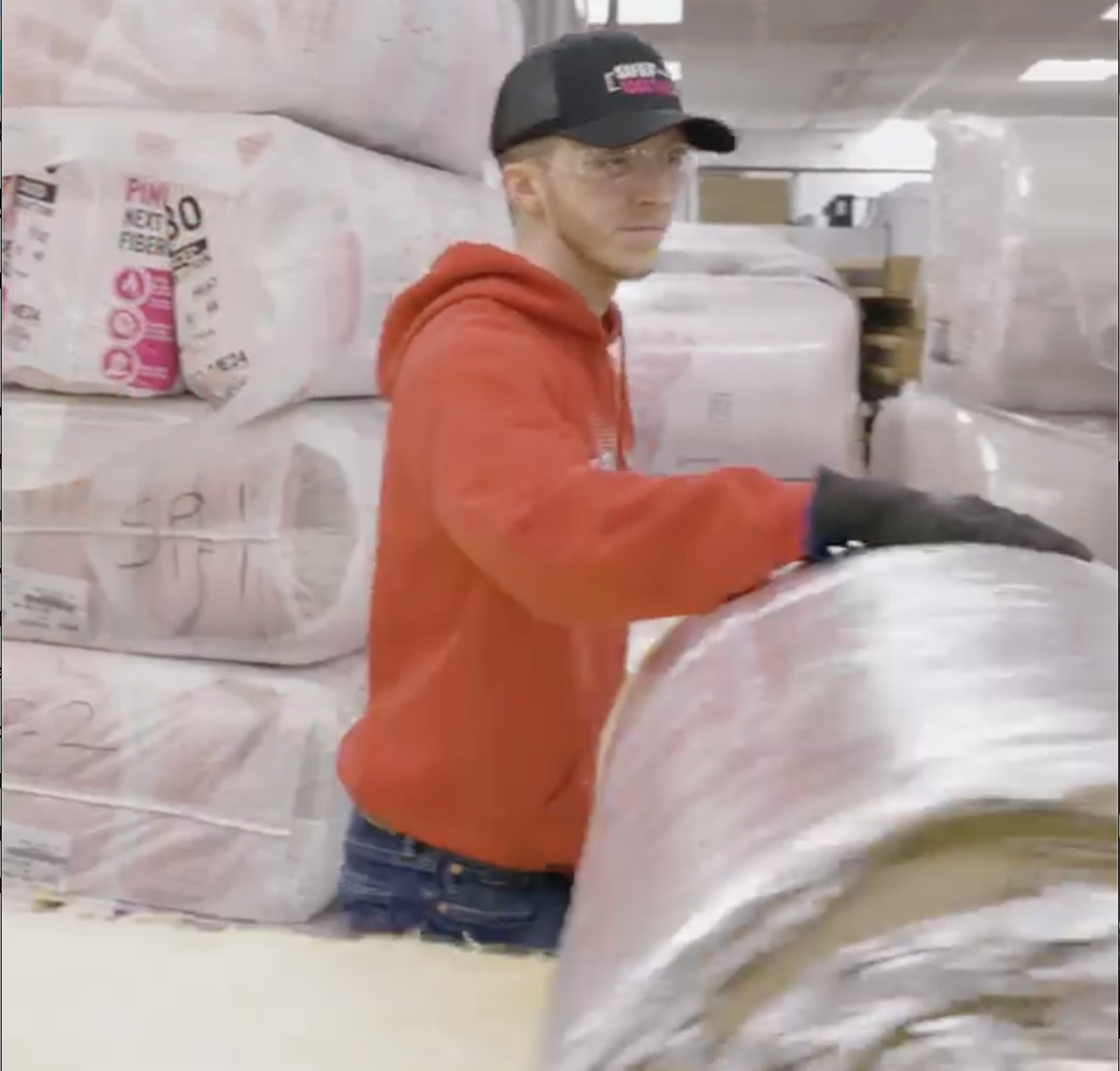 worker rolling up Mineral Wool