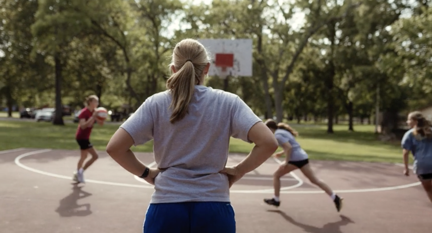 RaNae Isaak watching kids play basketball