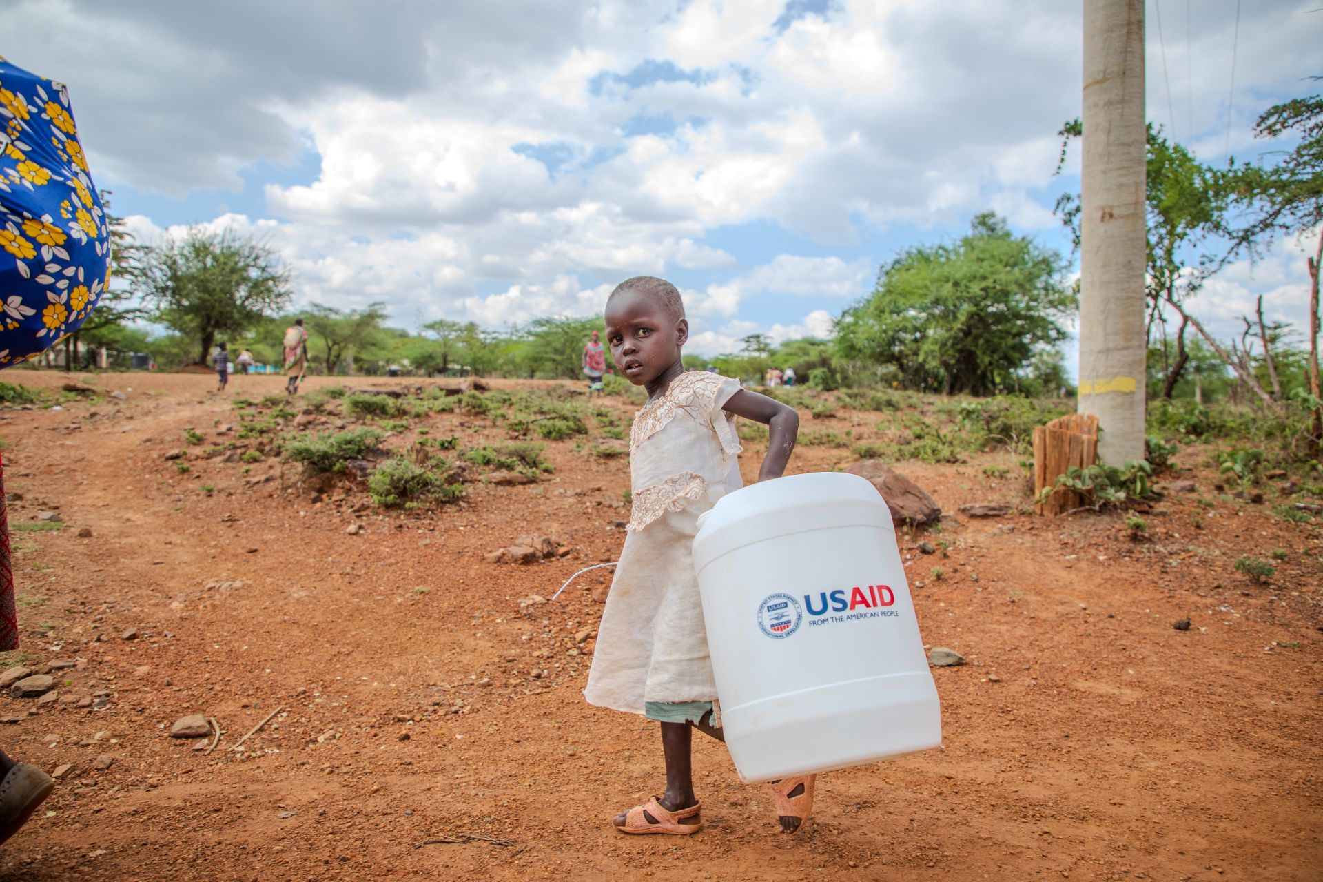 A girl carries water home in Kenya. 