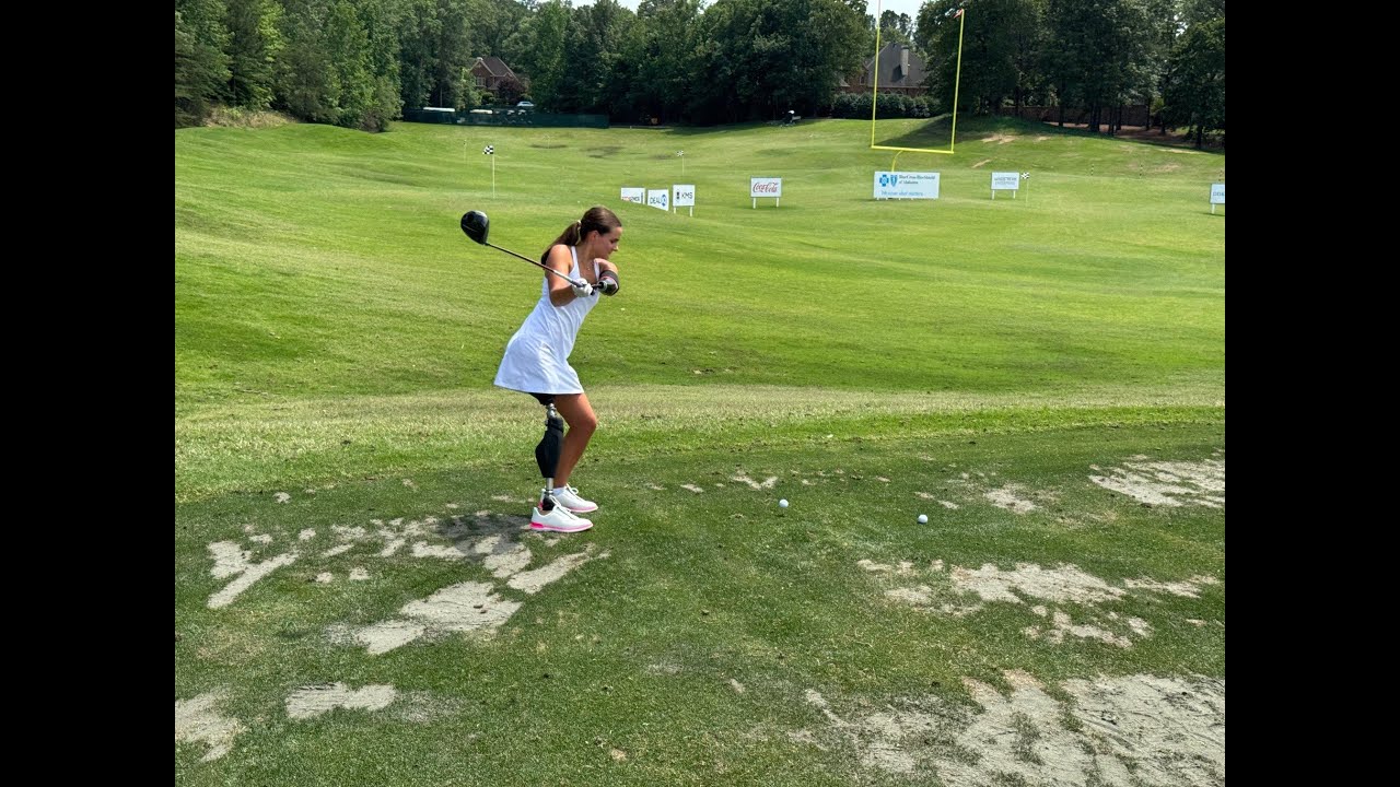 Lulu swinging a club on the green