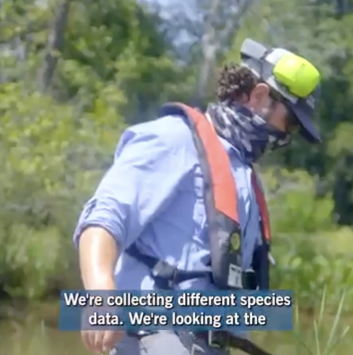 Worker collecting data on river