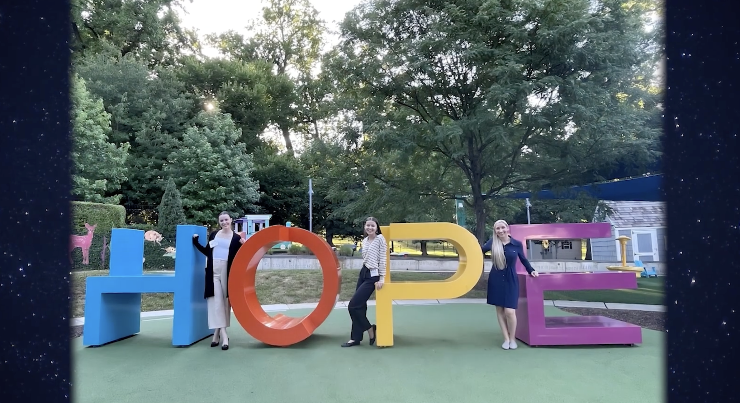 "HOPE" statue with people around it