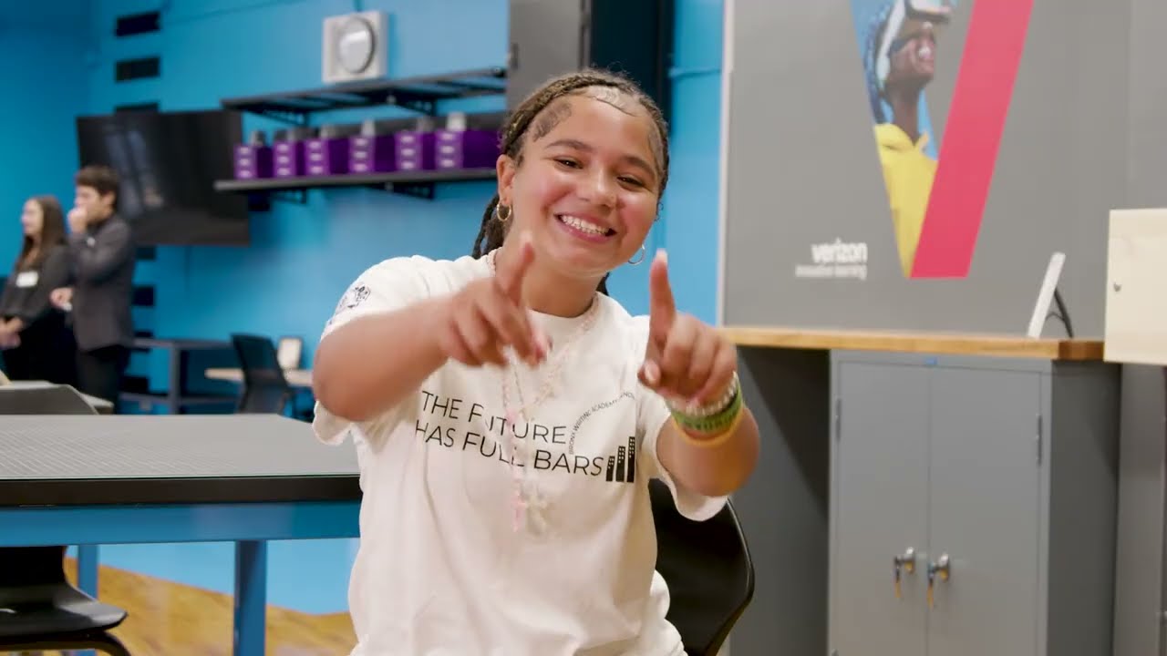 A person smiling and pointing to the camera