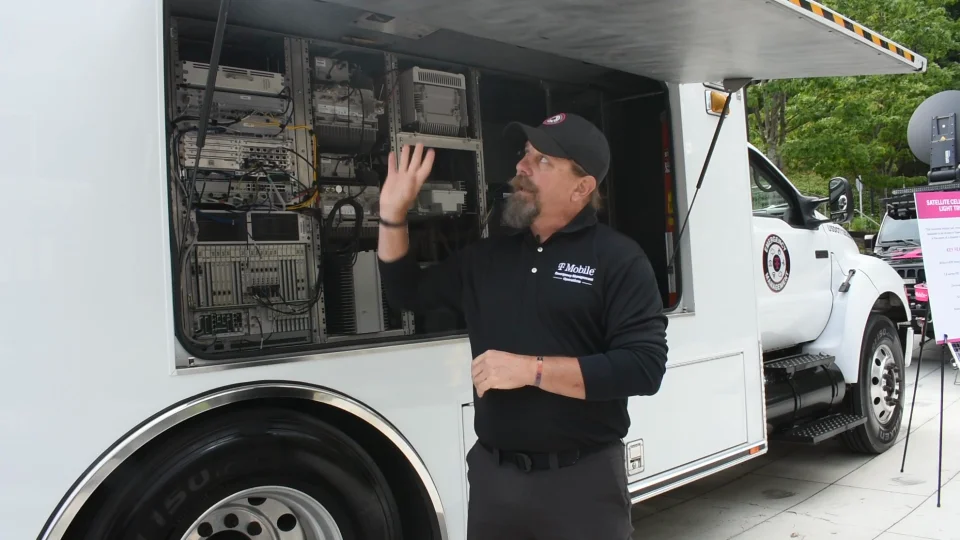 A person talking next to a vehicle