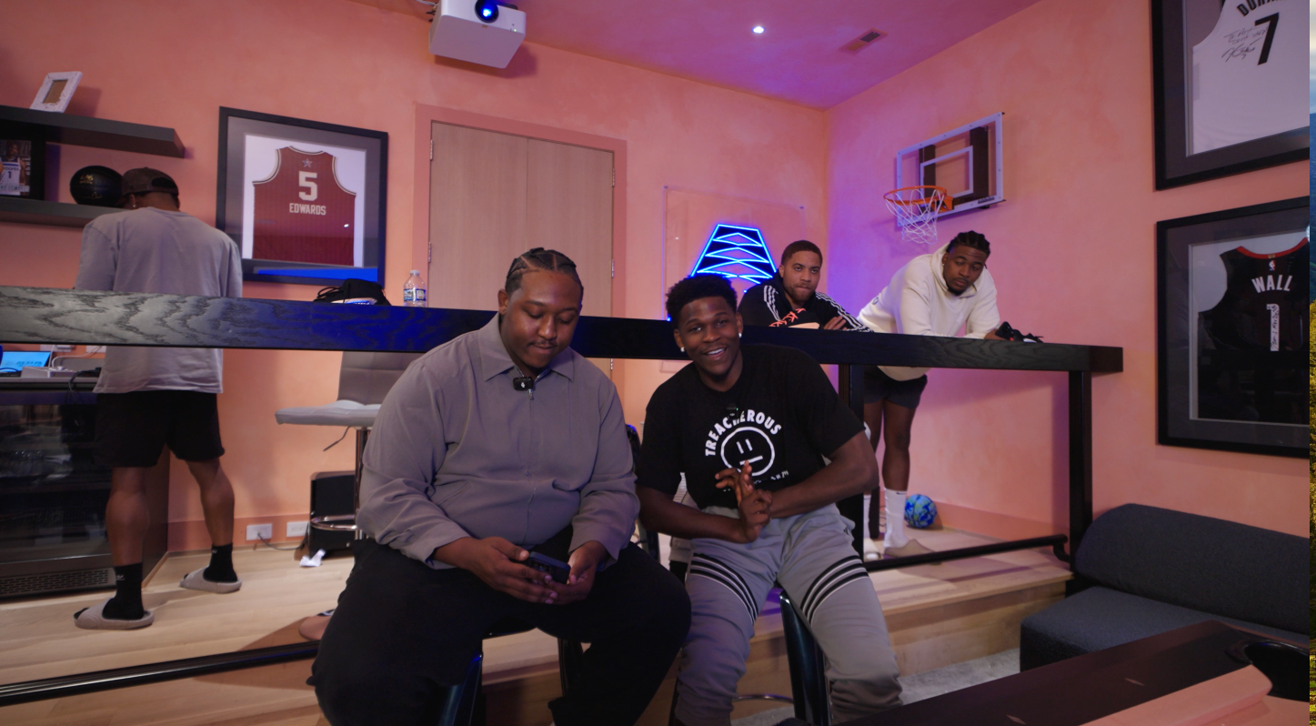 Two people sitting together with others looking on from above