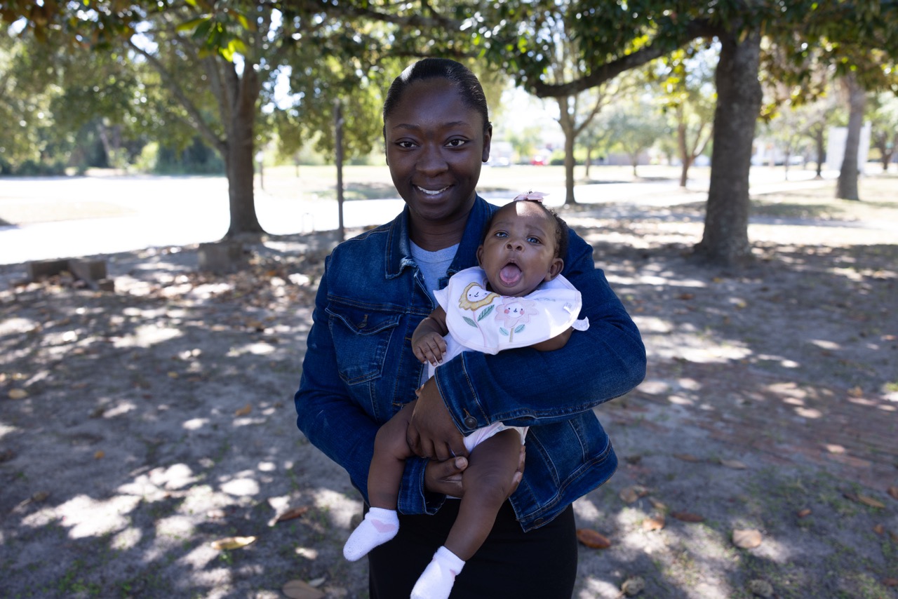 A young mother holding her baby