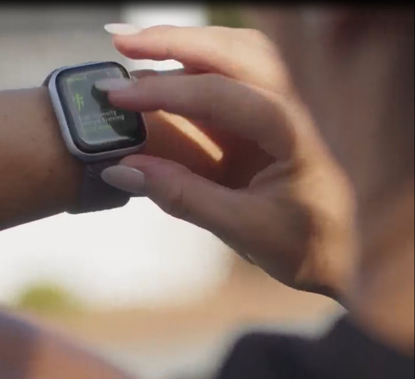 Woman scrolls through her Apple Watch exercise settings. 