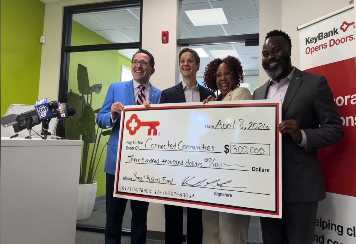 Team members from The KeyBank Foundation present a check for $300,000.