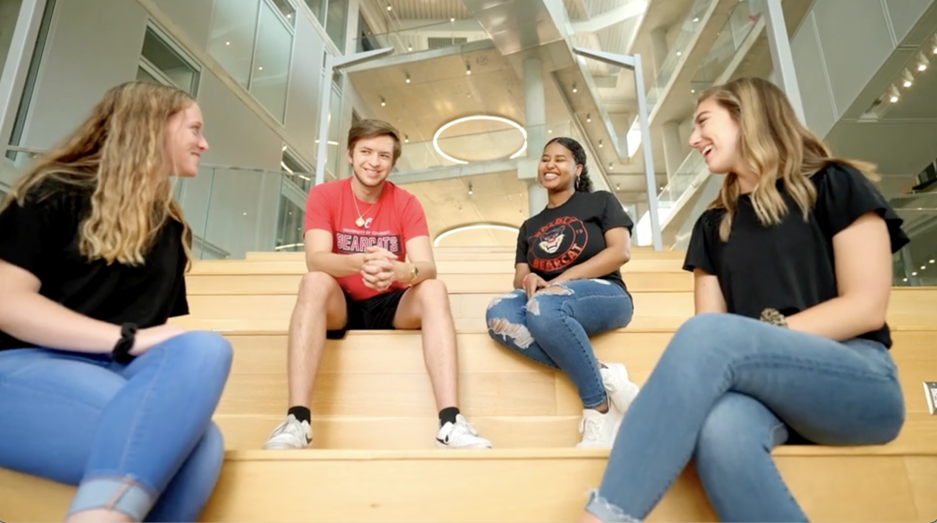 Four college students sitting on stairs