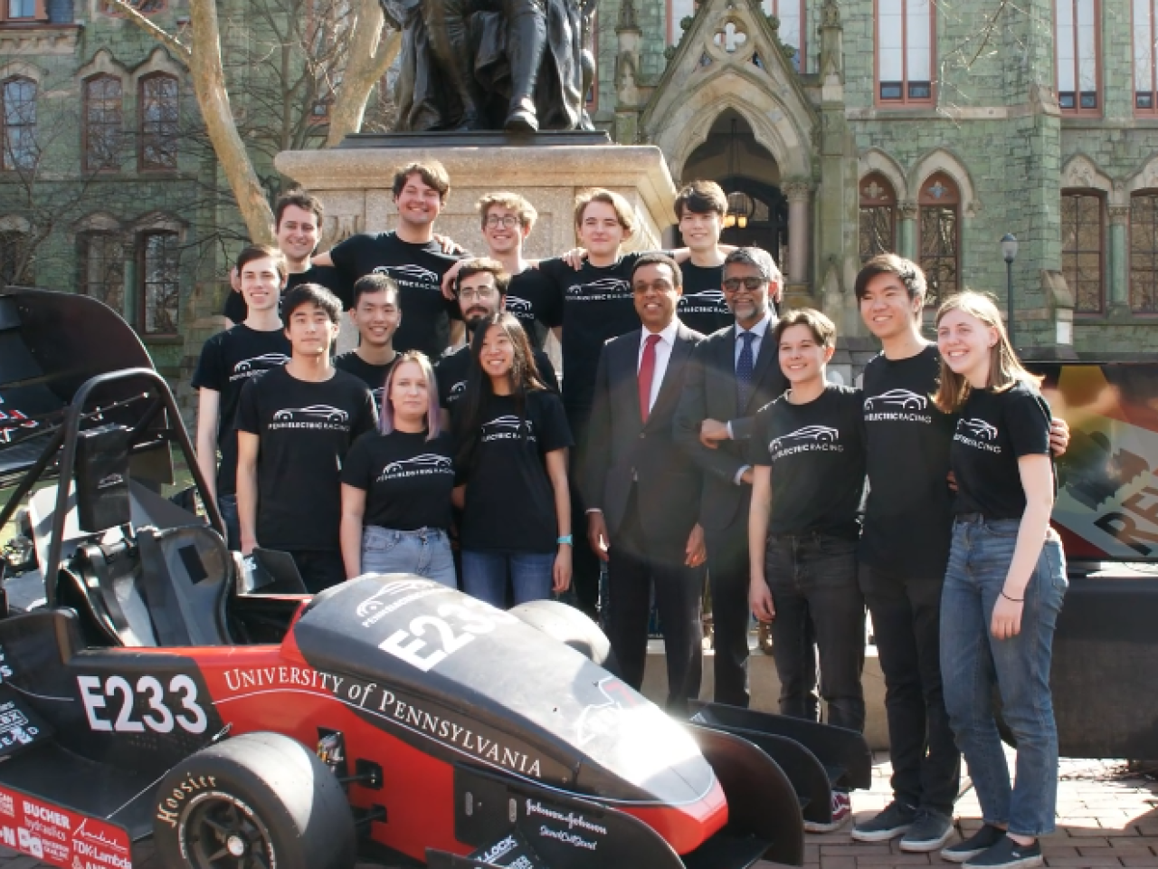 Group of students in front of race car